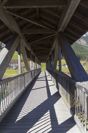 Wooden foot bridge over the Ziller River. Tyrol, Austria.
