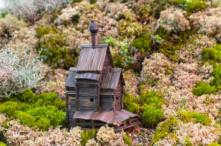 Modeling a rural landscape by installing a wooden model of a rural chopped church in a landscape created from colorful mosses.の写真素材