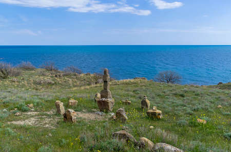 Cape Meganom, Crimea. A makeshift sanctuary to unknown gods, built, most likely, by "wild" tourists who come here. Sunny day at the end of April.の写真素材