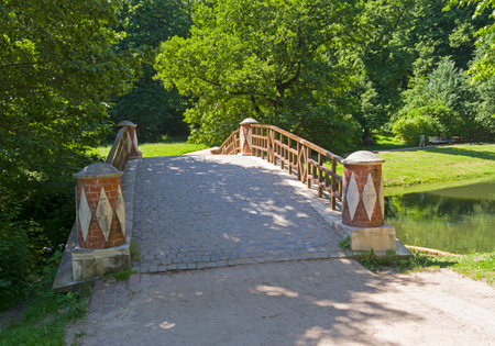 Moscow, Russia - June 20, 2021: A small beautiful footbridge over the ravine. Tsaritsynsky Park, Moscow, Russia. Sunny day in June.のeditorial素材