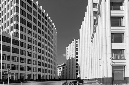 Moscow, Russia - July 18, 2021: Modern office building with arcuate facade. Ozerkovskaya embankment, Zamoskvorechye. Sunny day in July. Monochrome version.のeditorial素材