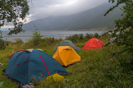 Bay of Lake Baikal, Russia - August  21, 2021: Hiking in a Great Baikal trail - a tent camp on the bank of Baikal. Cloudy day in August.のeditorial素材