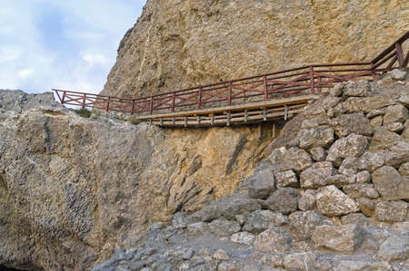 Pedestrian bridge on the destroyed area of the tourist trail. Cape Alchak, Sudak, Crimea.の写真素材