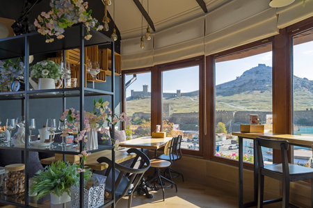 Sudak, Crimea - October 18, 2021: Interior of the cafe "Attic" in the resort town of Sudak, Crimea. From the cafe is a beautiful view of the Genoese Fortress.のeditorial素材