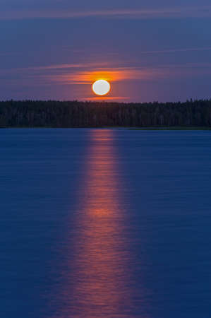 Full moon over the river bank. Reach of the Pista River, North Karelia, Russua, August.の写真素材
