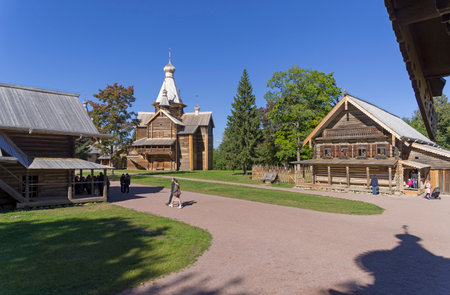 Vitoslavitsy, Veliky Novgorod, Russia - September 10, 2022: Peasant huts and wooden churches in the...