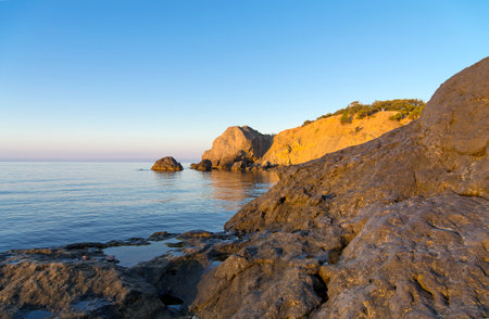 Quiet sunny morning on the Black Sea coast. coastal rocks. Crimea, between Sudak and Novy Svet.の写真素材