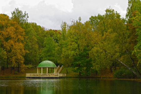 Pavilion on the surface of the pond. Cloudy day in early October.の写真素材