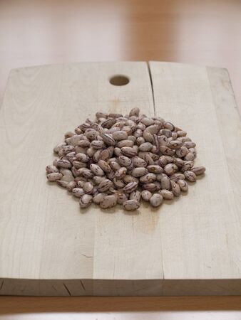 Close up view of organic Pinto beans on a board