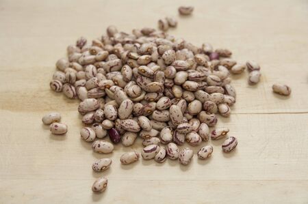 Close up view of organic Pinto beans on a board