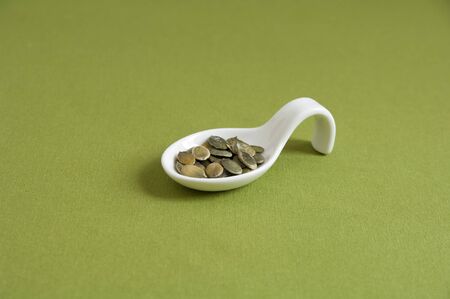 Close up view of organic Toasted Pumpkin Seeds in a spoonの写真素材