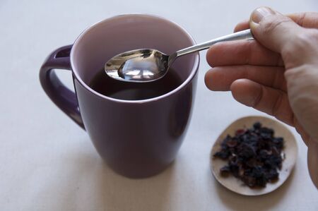 Dried Herbs and Fruits Preaparation in a bowl and Herbal Tea in a cup の写真素材