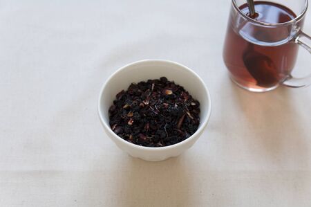 Dried Herbs and Fruits Preaparation in a bowl and Herbal Tea in a cup の写真素材