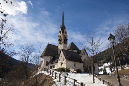 Scenic view of San Vigilio church in winter, Moena, Trento, Trentino Alto Adige, Italyの写真素材