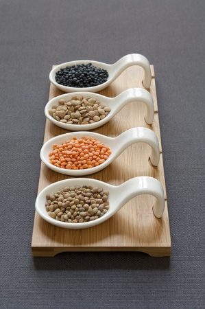 Close-up view of four different variety of Organic Lentils   back to front  Black Beluga, Green, Red, Small Umbrian Lentils の写真素材