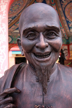 old chinese monk be kind and smile,sculpture in thailandの写真素材