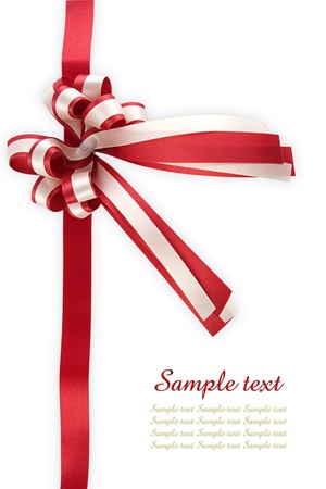 Shiny red ribbon bow on white background with copy spaceの写真素材