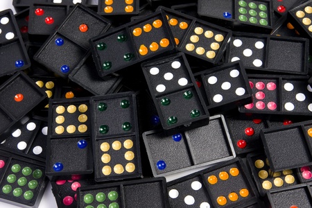 Domino pieces randomly spread on white background. Leisure and game concept.