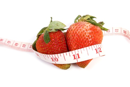 Image of two isolated strawberries with tape measureの写真素材