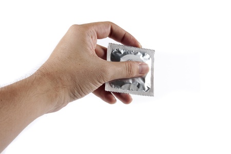 Hand offering a condom on white backgroundの写真素材