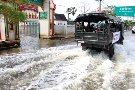 Bangkok, Thailand - November 20, 2011: A group of Royal Thai Army truck driving in a flooded street in front of Soi Watcharaphon to help the flood victemのeditorial素材