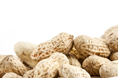 Peanut in shell snack on white plate - shallow DOF focus in the middleの写真素材