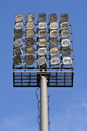 A bank of lights at a football stadium, shot in the daytime.の写真素材