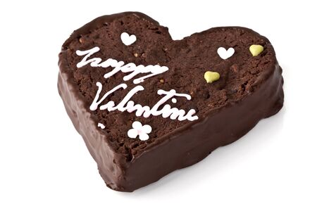 Heart shaped slice of a brownie on white backgroundの写真素材