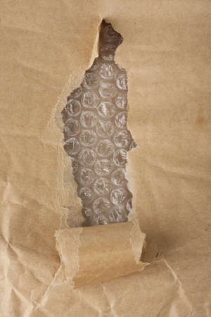 Ripped pieces of craft paper and bubblewrap ready for you to use your design skills on