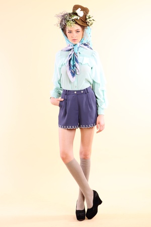 Fashion model in spring light blue and purple clothes on beige background の写真素材