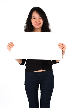 Beautiful young girl smiling holding big blank cardの写真素材