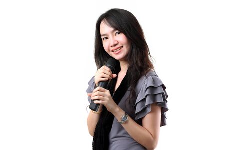 Asian karaoke singer isolated on a white background の写真素材