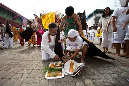 PHUKET, THAILAND - OCTOBER 20, 2012 : A Taoist devotee participates in the Phuket Vegetarian Festival on Oct 20, 2012 in Phuket, Thailand. The festival ritual mortification is practiced to appease the Gods.のeditorial素材
