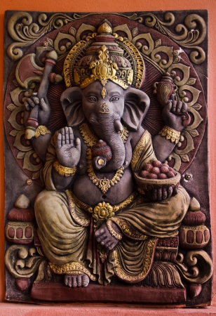 Sculpture of Gannesa hindu god on the orange wall の写真素材