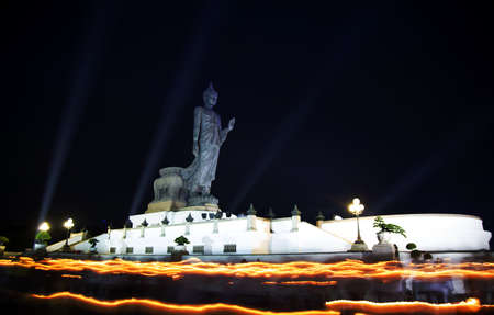 Buddhists walk with lighted candles in hand around the Buddha during Visakha Puja Dayの写真素材