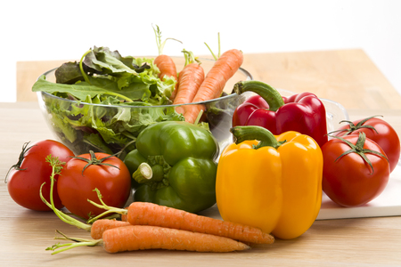 Mix of vegetables on salad on wood background.の写真素材