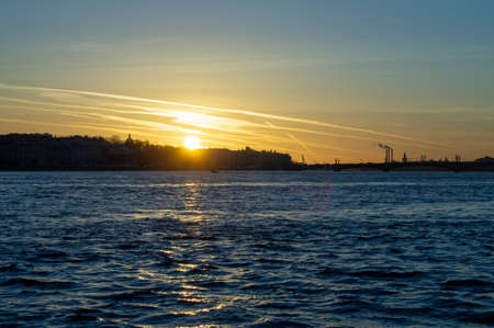 Sunset sky in city with big waterの写真素材