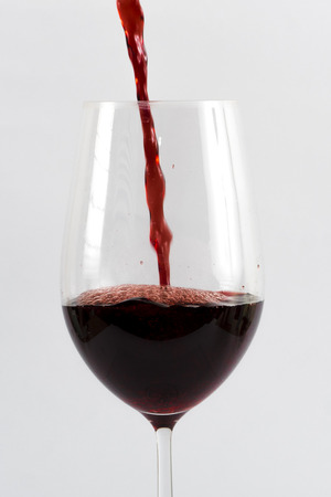 Image of red wine in the glass isolatedの写真素材
