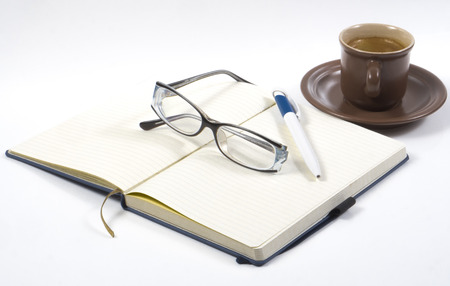 Image of notebook coffee cup and glassesの写真素材