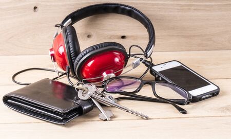 Image of wallet phone and haedphones, close up.