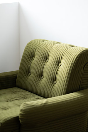 green sofa in the room, closeup of photo with soft focus
