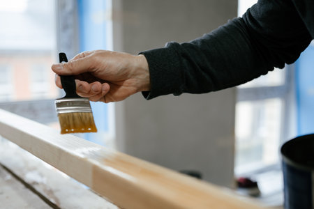 Hand Painting Wooden Surface with Paintbrush