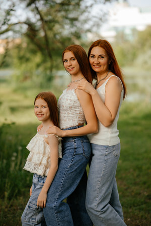 Three Women Enjoying Time Together in a Park Settingの写真素材