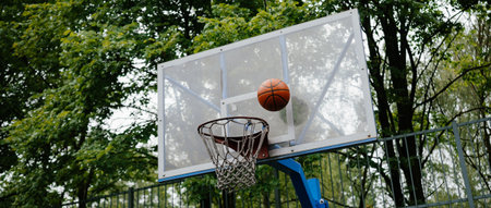 Basketball Mid-Air Shot Approaching Hoop in Outdoor Court