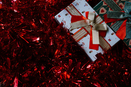 Festive Gift Boxes with Sparkling Red Tinselの写真素材
