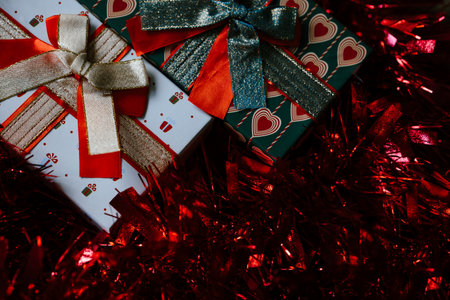 Festive Gift Boxes with Sparkling Red Tinselの写真素材