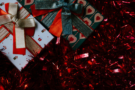 Festive Gift Boxes with Sparkling Red Tinselの写真素材