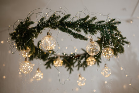 Stunning Christmas Decor with Hanging Lights and Greeneryの写真素材