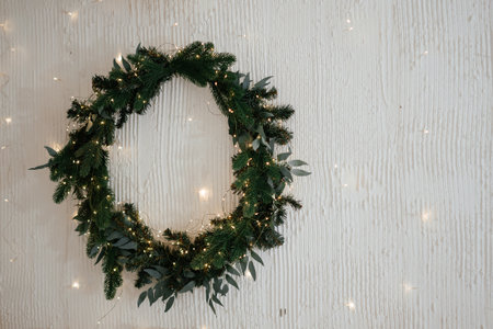 Evergreen Wreath with Twinkling Lights on Wallの写真素材