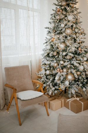 Elegant Christmas Tree with Gifts and Cozy Chairの写真素材